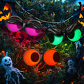 Three pairs of flashing peeping eyes glowing magenta, green and orange in a dark bush at night