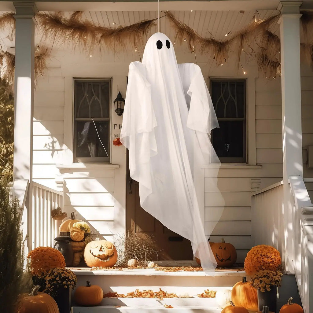 47 in white hanging ghost hanging from a porch ceiling above steps with pumpkins